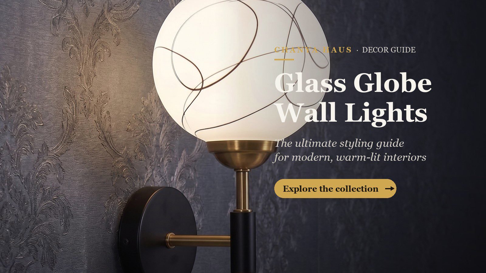 Glass globe wall light with brass stem on a dark decorative wall — Chanya Haus styling guide